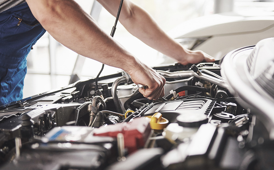 Chevrolet service technician performing routine maintenance including oil change, tire inspection, and brake check in Woodruff, SC