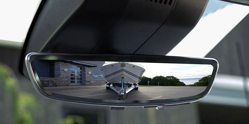 Boat being towed in front mirror of Silverado 2500