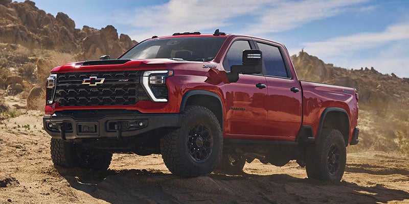 Red Silverado 2500 on rugged terrain