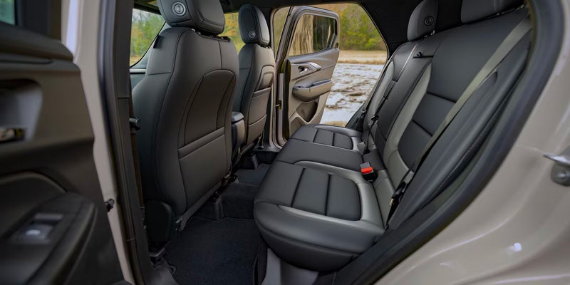 Interior view showing the two-tone black and gray leatherette rear seating and spacious cabin of a Chevrolet Trailblazer.